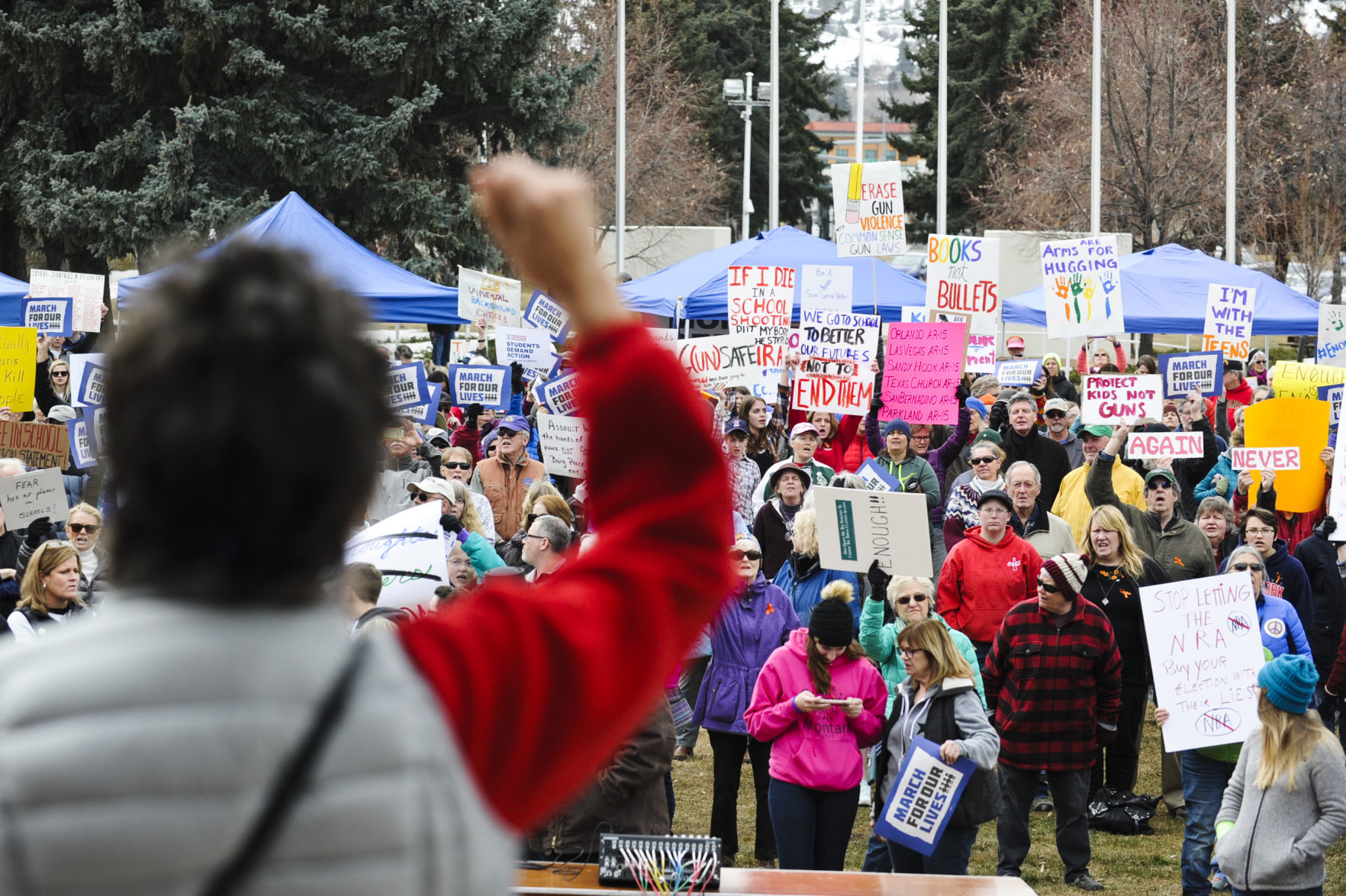 A singer from the Montana Women's Chorus raises a fist in the air while singing at the March for Our Lives demonstration Saturday at Memorial Park.